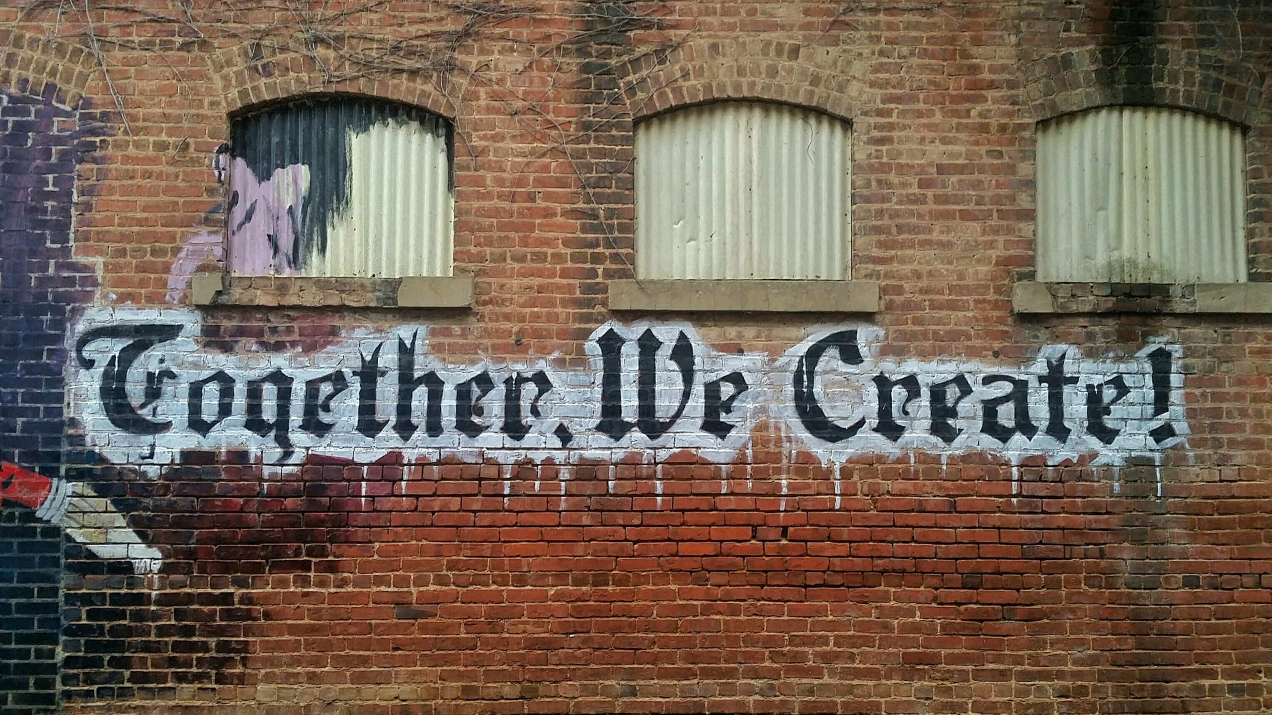 mural on building that says together we create