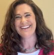brown-haired woman smiling at camera