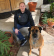 man and dog looking at camera
