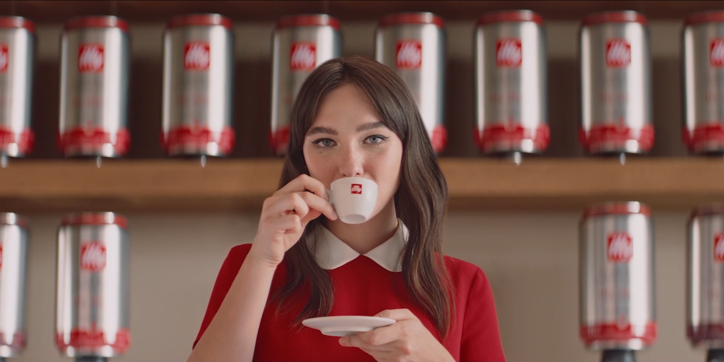 woman sipping out of illy mug