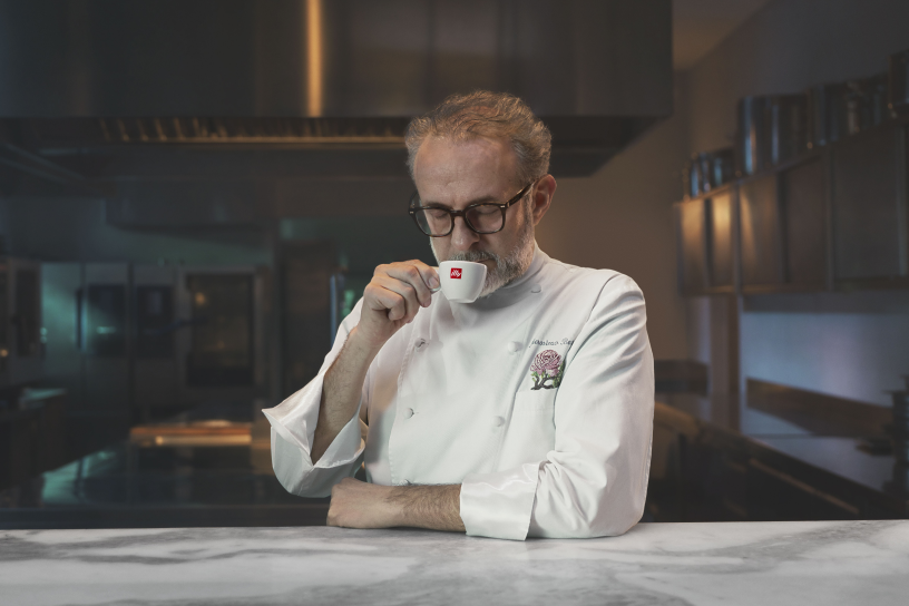 man drinking cup of illy capuccinno
