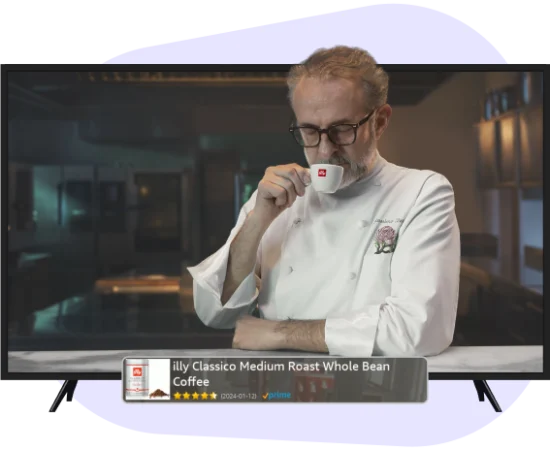 man drinking cup of illy capuccinno in front of tv with ad