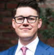 man in glasses looking at the camera