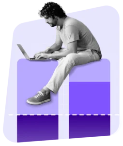 man on laptop sitting on graph