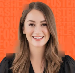 woman smiling in front of orange background