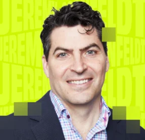 man smiling in front of green background