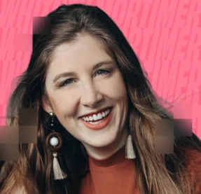 woman smiling in front of pink background