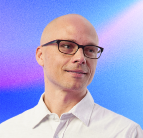man with glasses smiling
