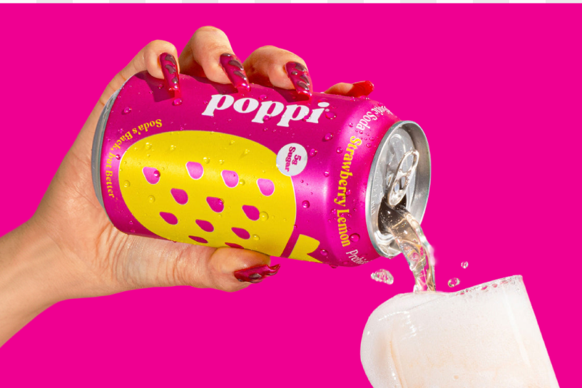 woman pouring poppi soda