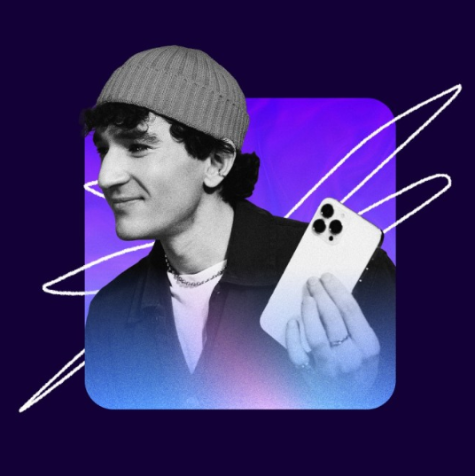 man wearing beanie and holding phone